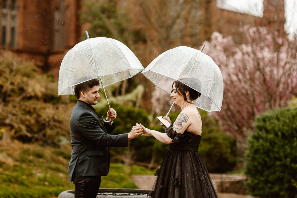 romantic rainy elopement ceremony in washington dc, the couple is standing under clear umbrellas