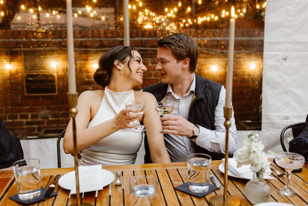bride and groom drinking champagne together