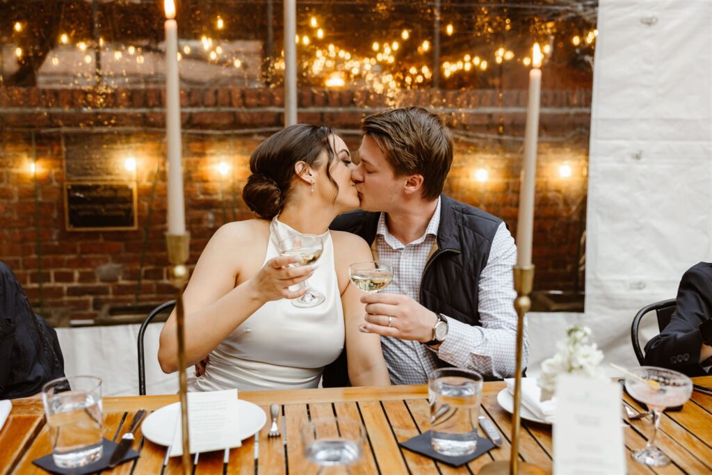 bride and groom drinking champagne together