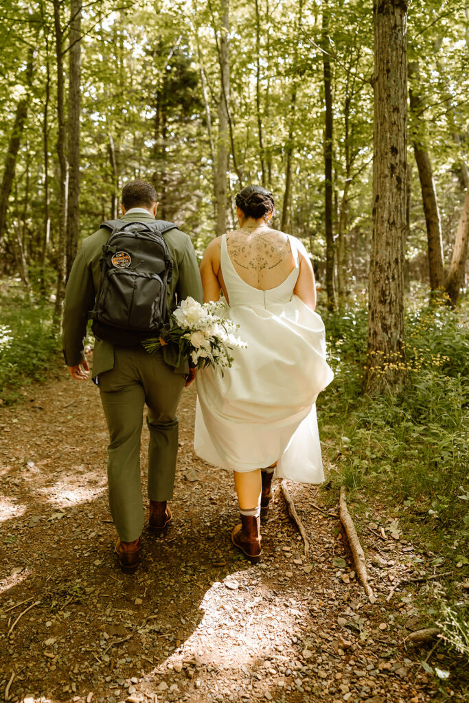 bride and groom going on a hike together during their full day elopement at shenandoah national park