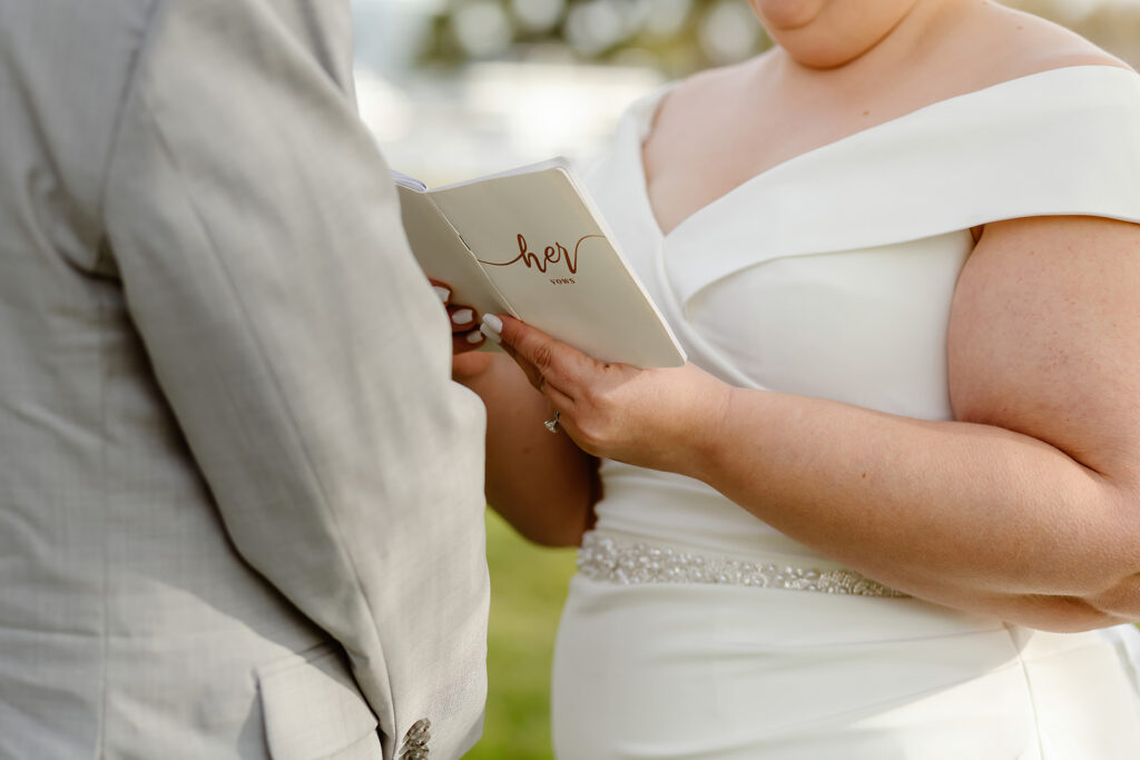 close up of bride holding vow book