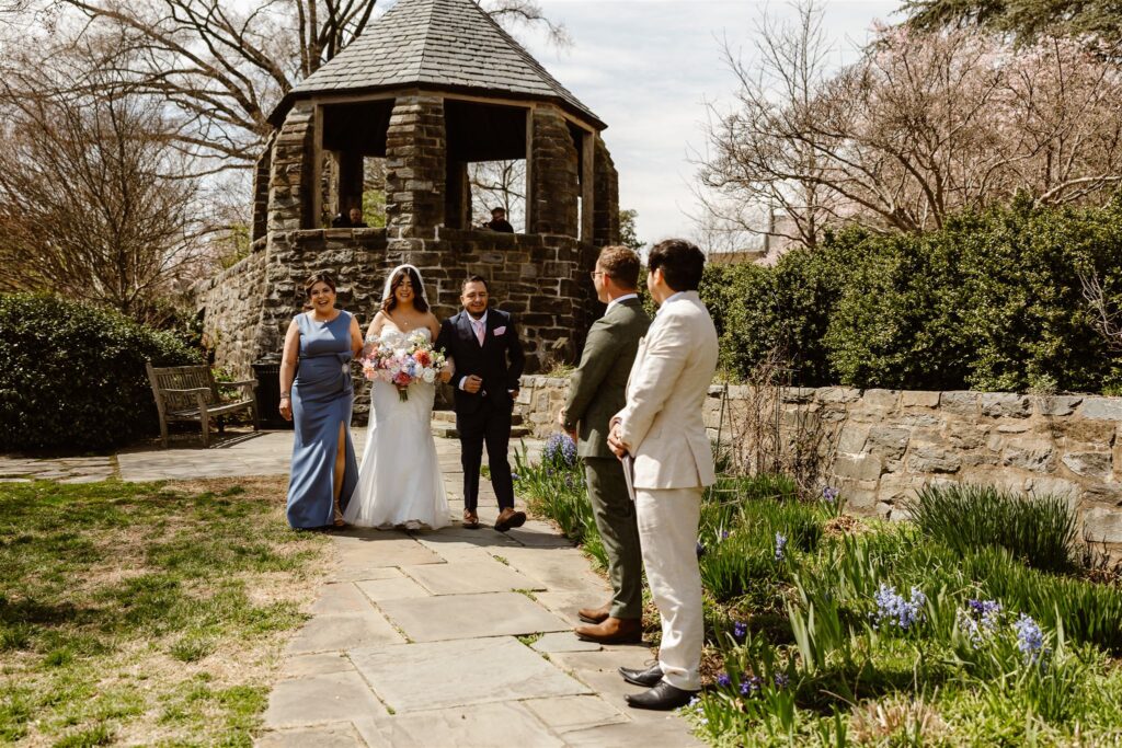 parents walking bride down a path to the elopement ceremony in dc