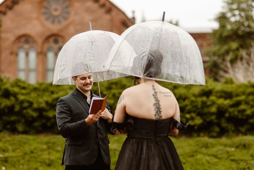 rainy vow exchange in Smithsonian gardens during a dc elopement, bride and groom holding clear umbrellas