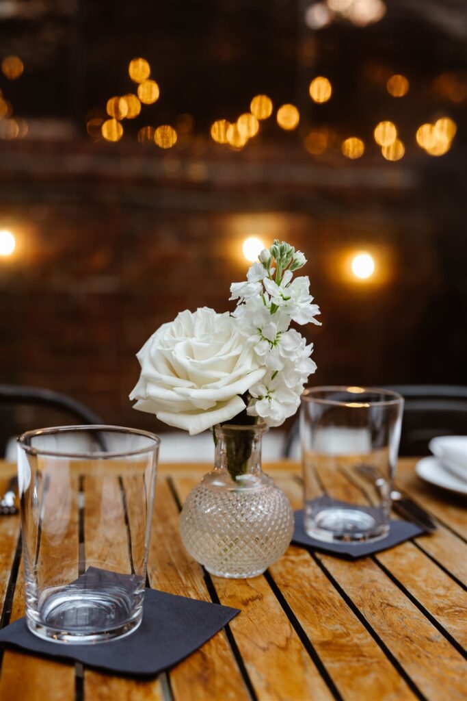 small wedding reception table decor of white flowers