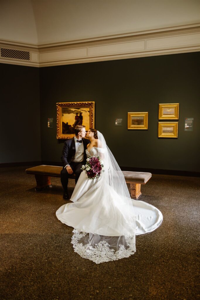 bride and groom sitting in a room with vintage paintings at the freer gallery of art