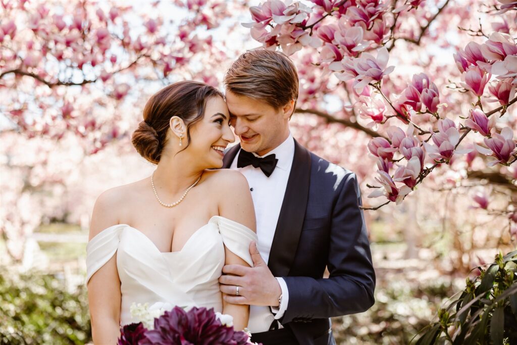bride and groom surrounded by cherry blossoms at a dc elopement location