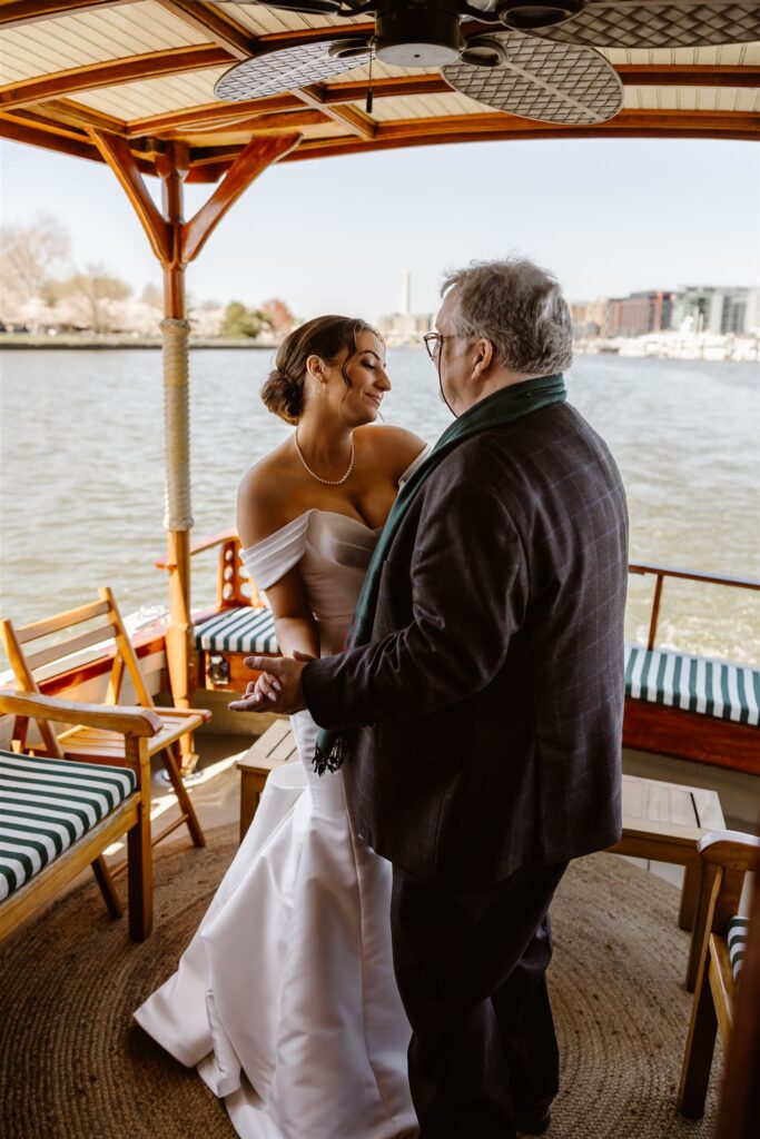 bride and dad dance on yacht during a yacht wedding celebration in DC