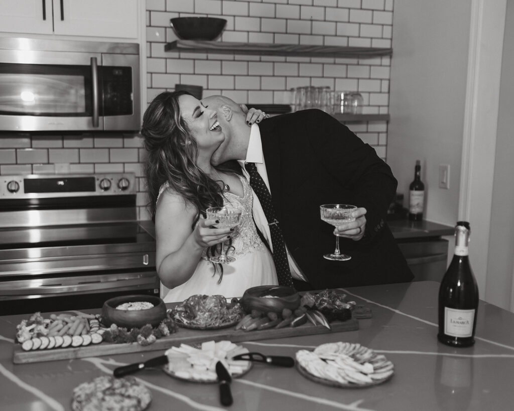 bride and groom enjoying champagne and charcuterie snacks