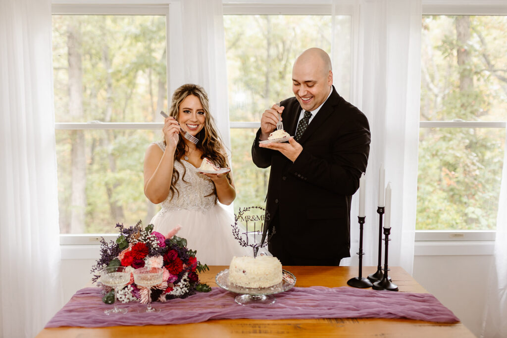bride and groom enjoying their elopement cake inside the airbnb