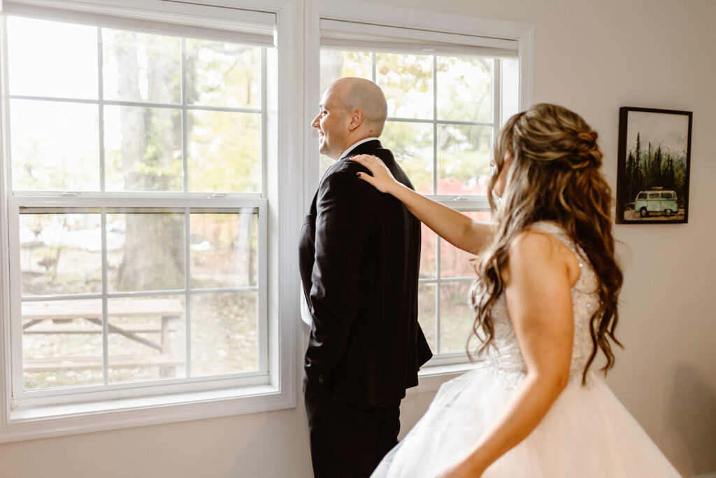 emotional bride and groom first look at the airbnb
