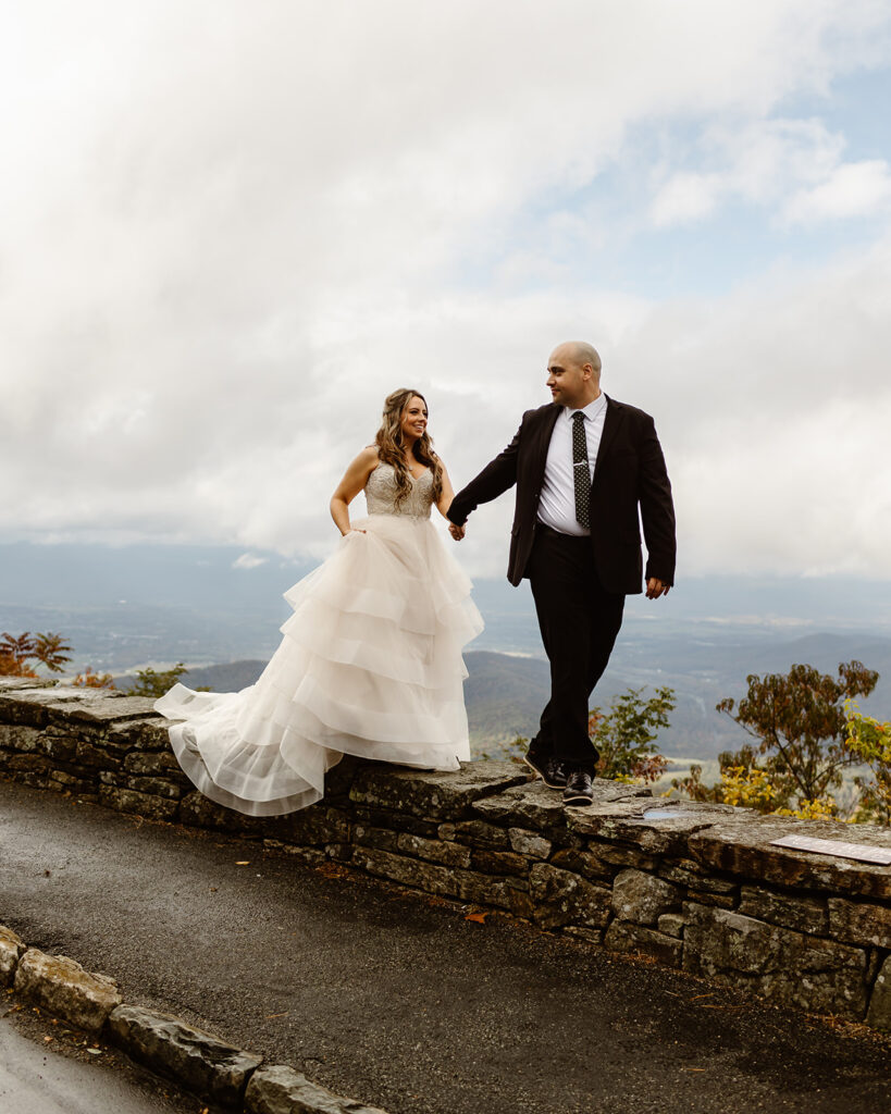 bride and groom posing on foggy overlook at Stony Man summit in Shenandoah during their Shenandoah National Park elopement in October