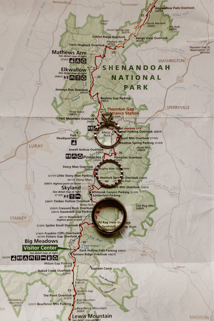 Flat lay of rings, and mountain map for Shenandoah elopement