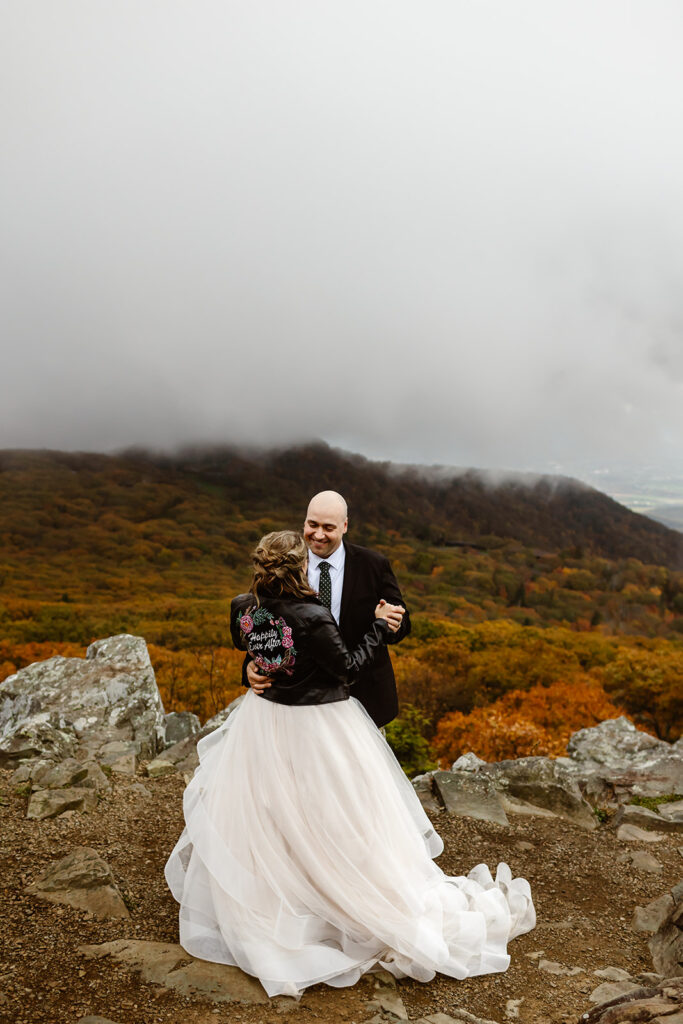 bride and groom first dance surrounded by fall foliage in shenandoah