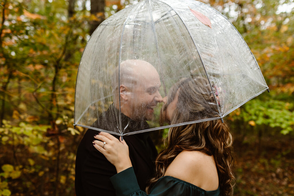 sweet couple under a clear umbrella during their session in Shenandoah National Park