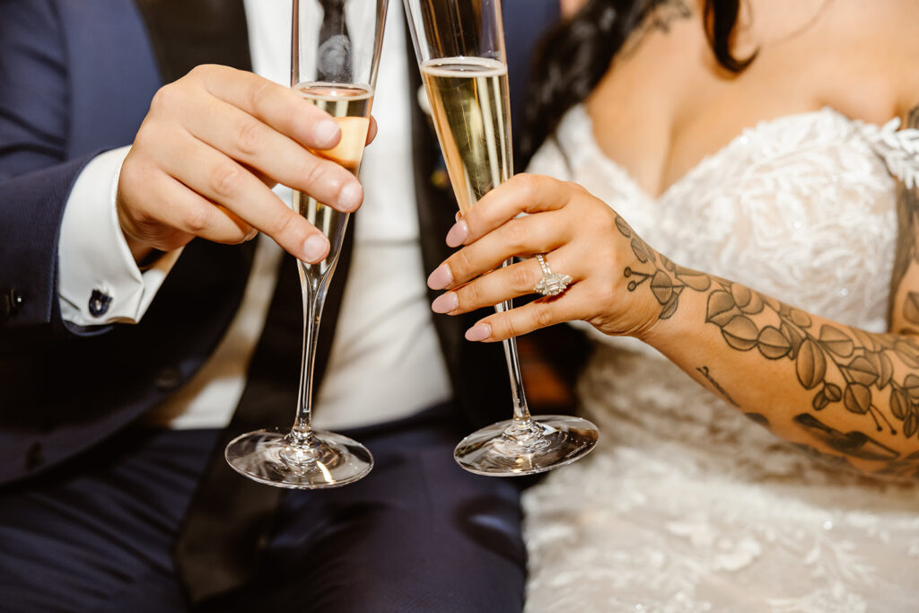 bride and groom toasting champagne