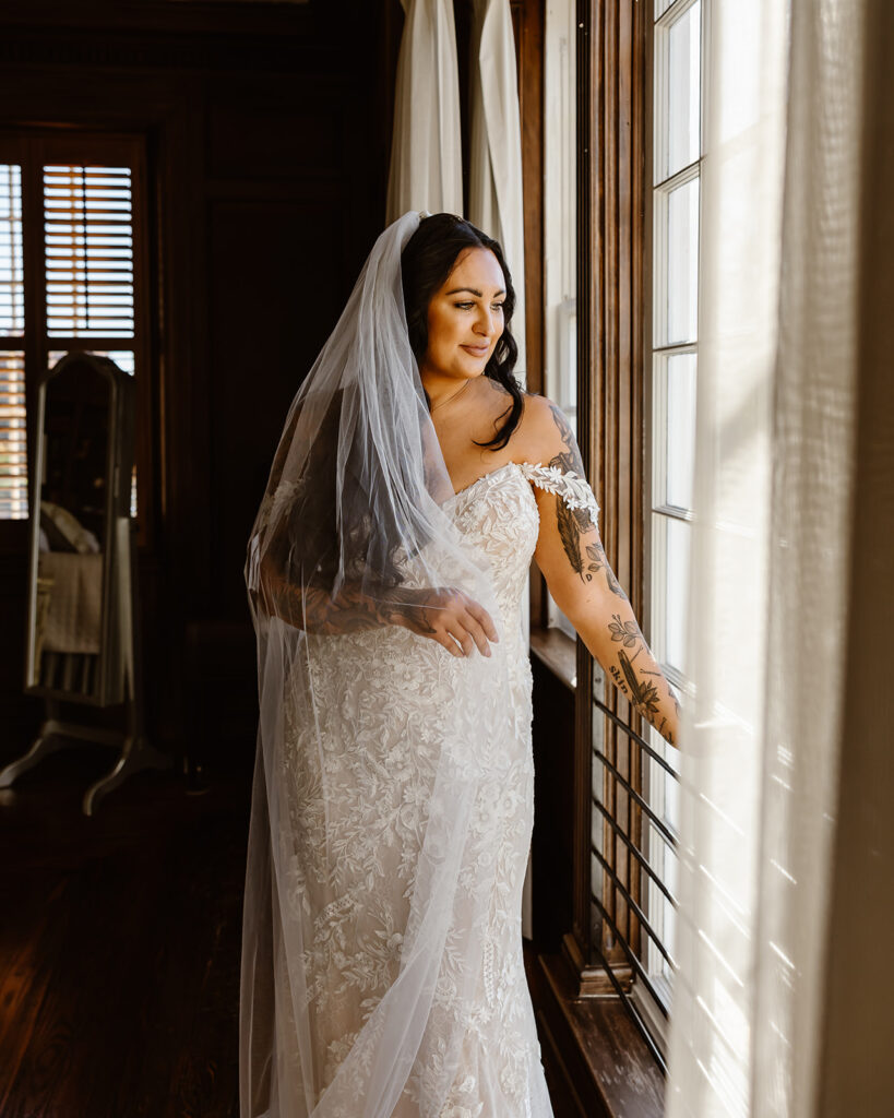 bridal portrait at a window in a cozy inn