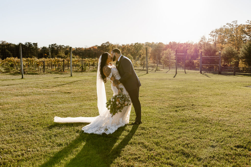 bride and groom walking in the vineyards during their winery micro wedding in northern virginia