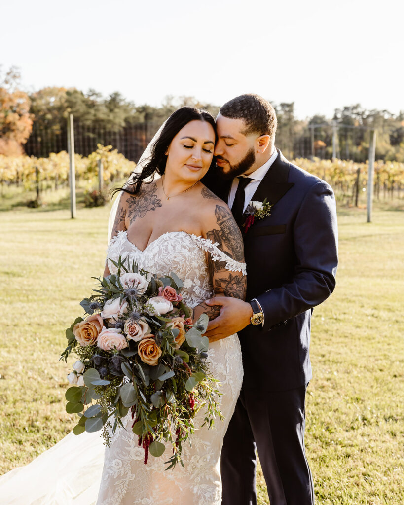 bride and groom walking in the vineyards during their winery micro wedding in northern virginia