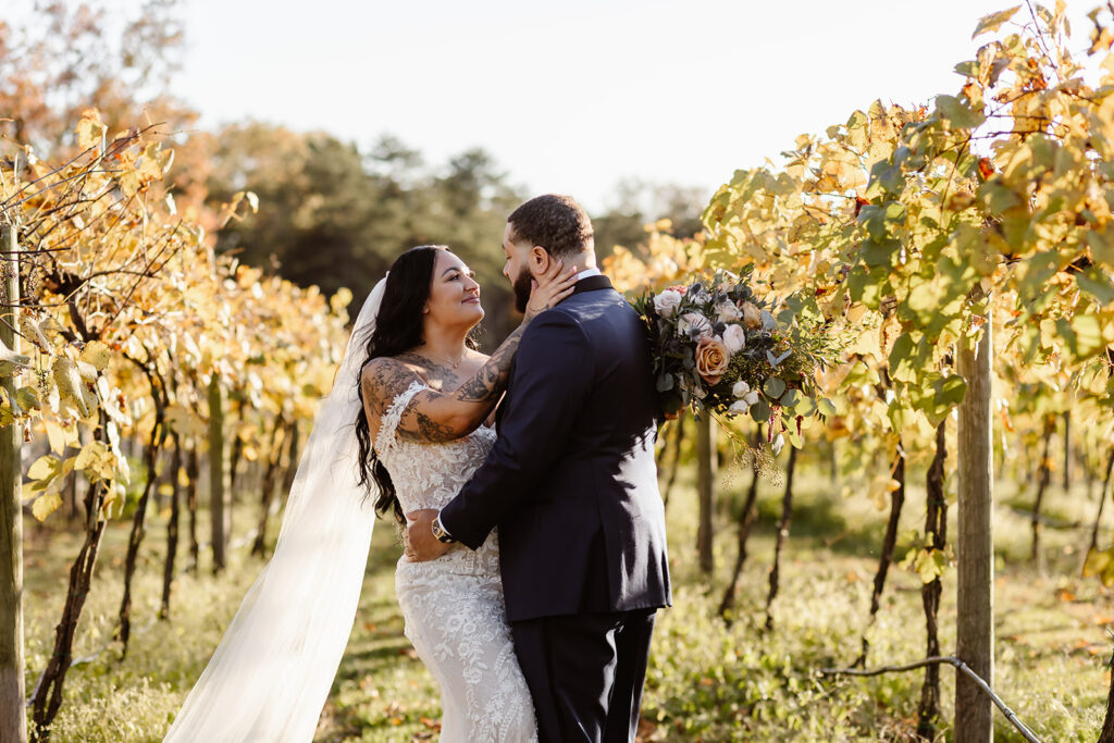 bride and groom surrounded by the vineyard at the winery at bull run