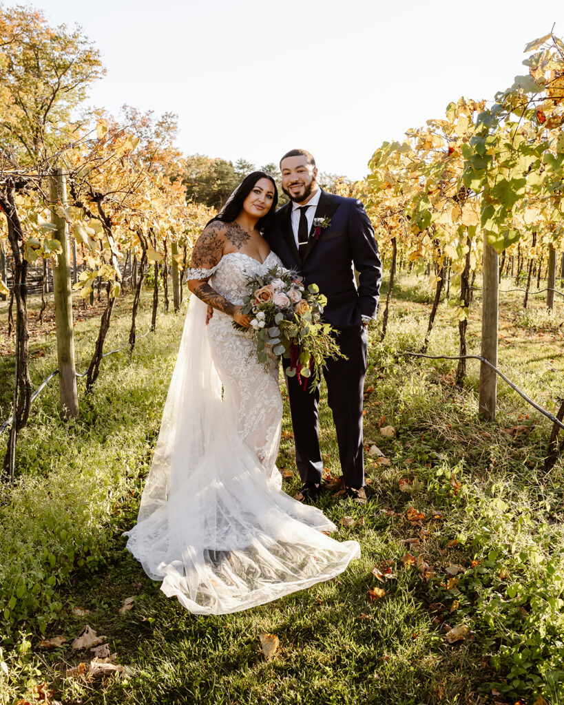 bride and groom walking in the vineyards during their winery micro wedding in northern virginia
