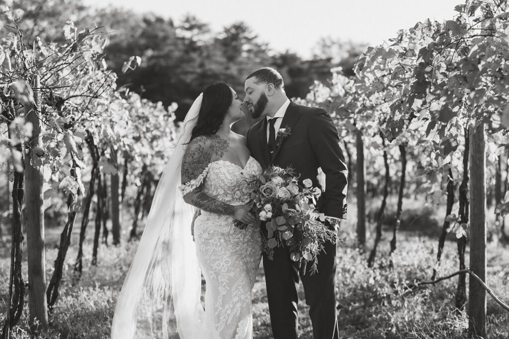 bride and groom surrounded by the vineyard at the winery at bull run