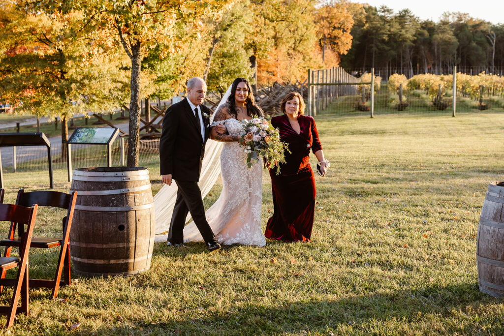 bride walking down the aisle with her parents