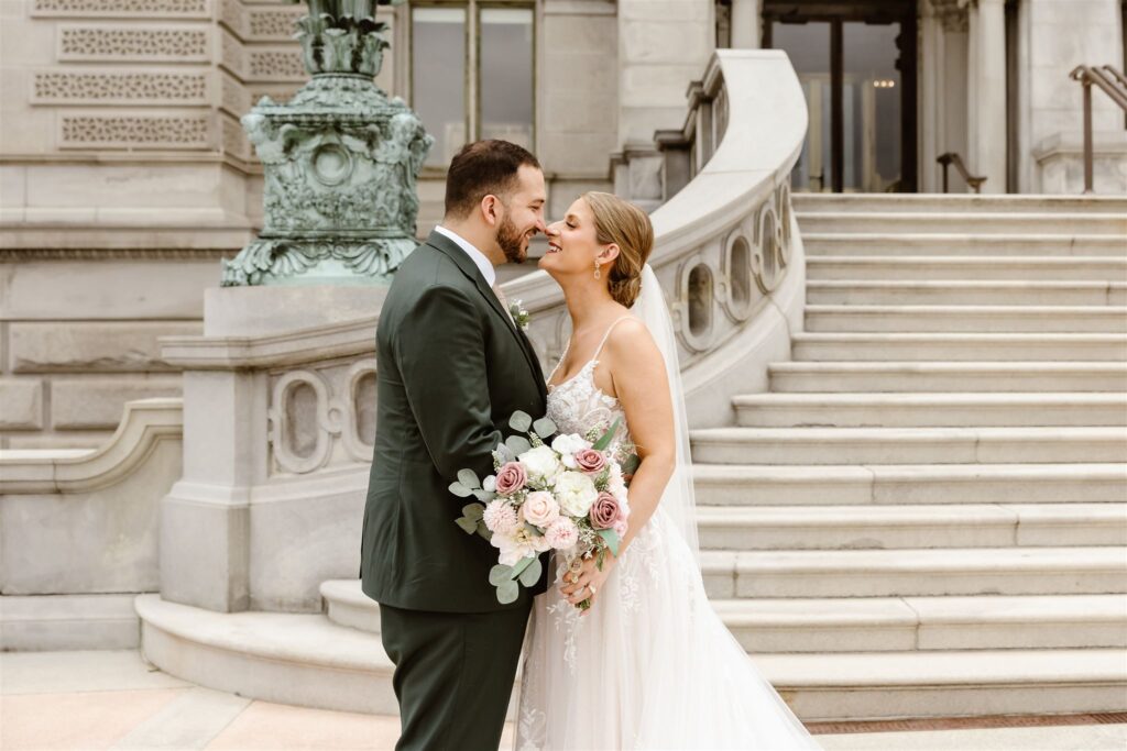 sweet elopement couple almost kissing on the stairs in front of the library of congress