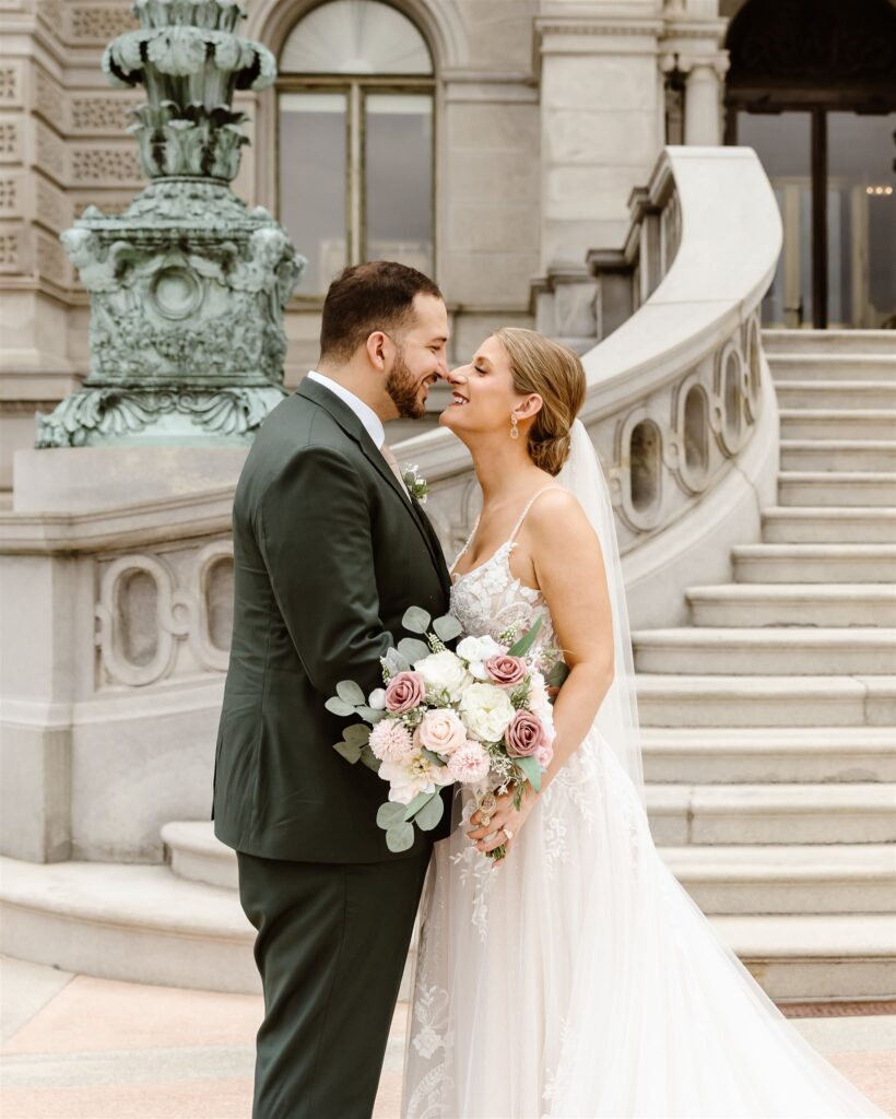 sweet elopement couple almost kissing on the stairs in front of the library of congress
