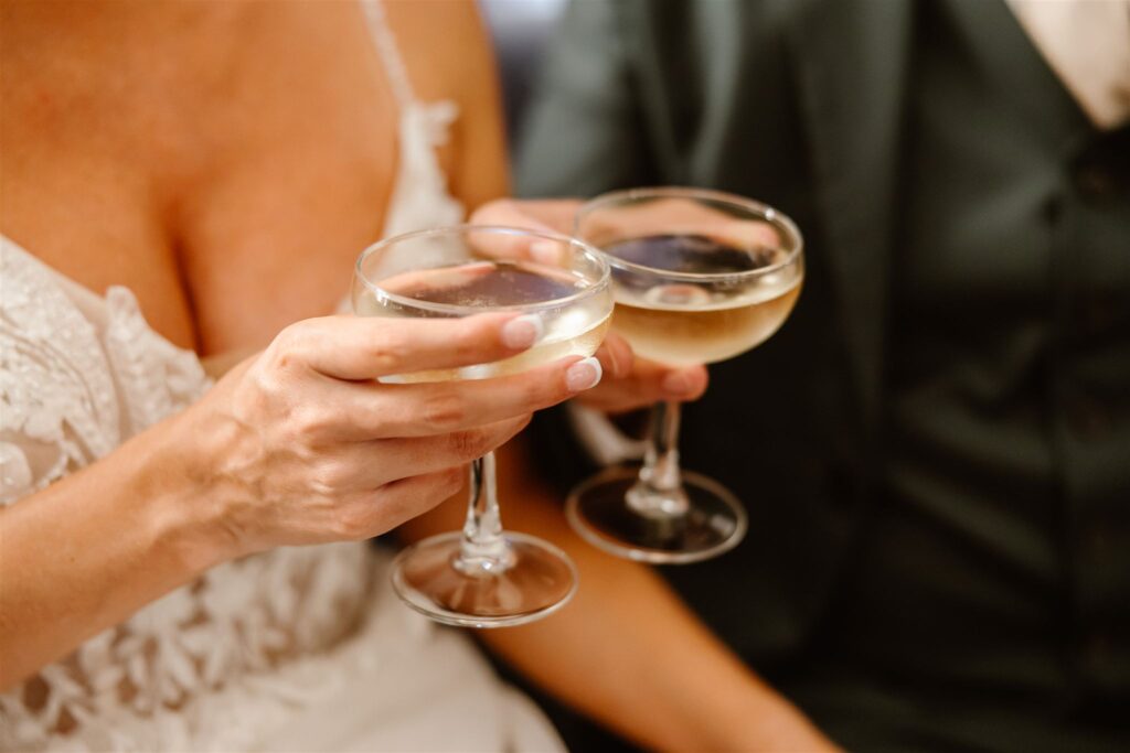 bride and groom celebrating with drinks
