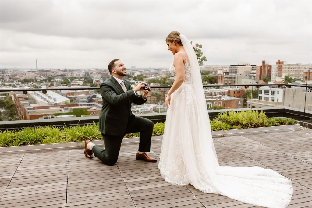 bride and groom surprise proposal during the elopement first look on the rooftop at the line hotel dc