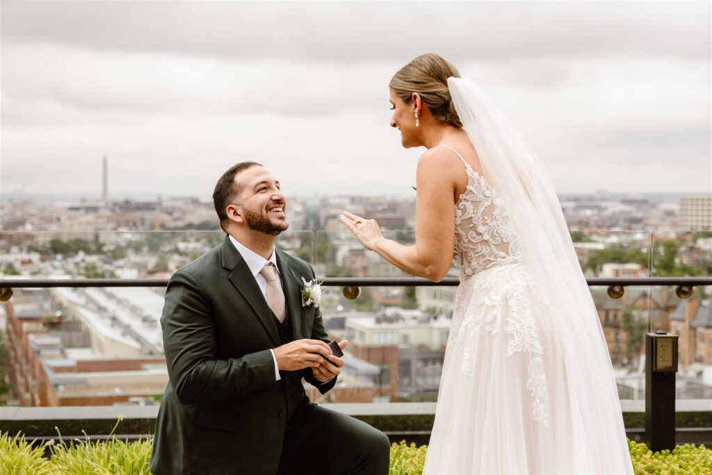 bride and groom surprise proposal during the elopement first look on the rooftop at the line hotel dc