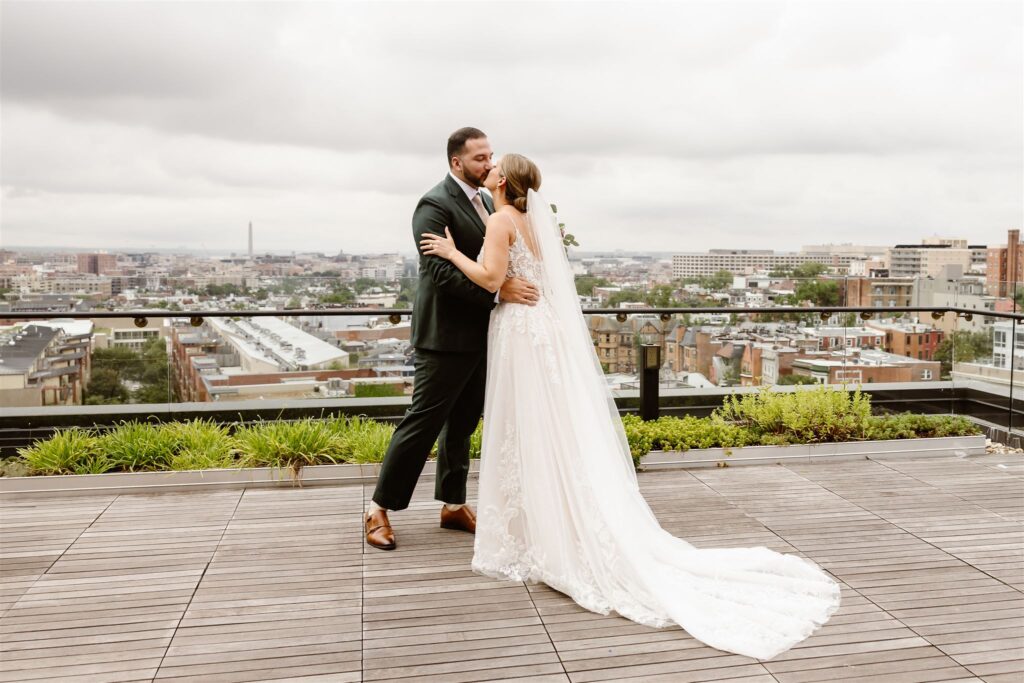 bride and groom surprise proposal during the elopement first look on the rooftop at the line hotel dc