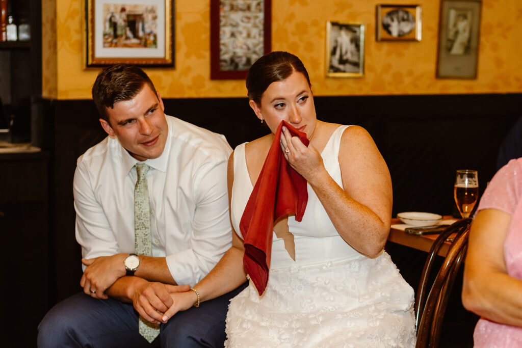 candid bride and groom in tears during speeches