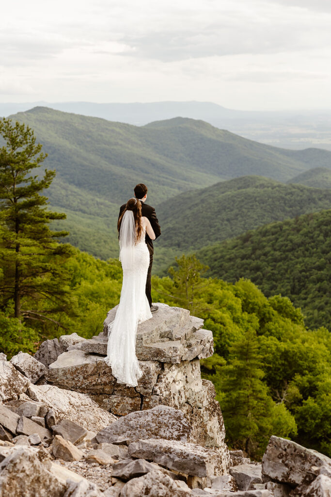 elopement couple hugging at a mountain overlook during their shenandoah summer elopement