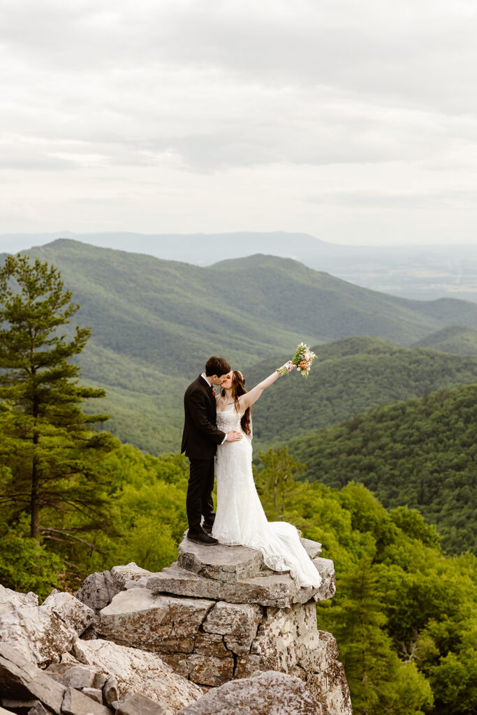 elopement couple kissing at a mountain overlook during their shenandoah summer elopement