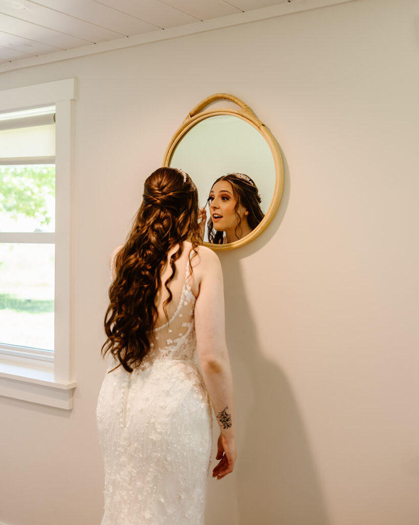 bride getting ready in front of a mirror