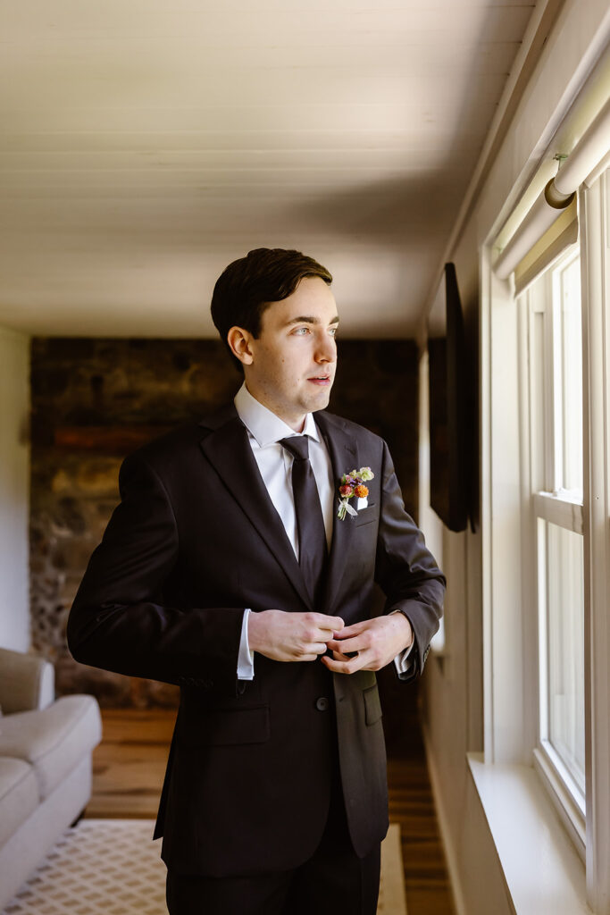 groom getting ready by a window