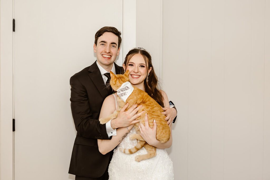 bride and groom with their cats at the airbnb
