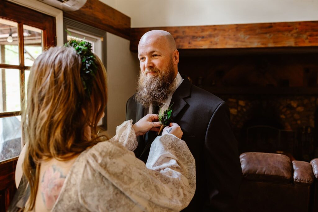 bride and groom helping each other get ready