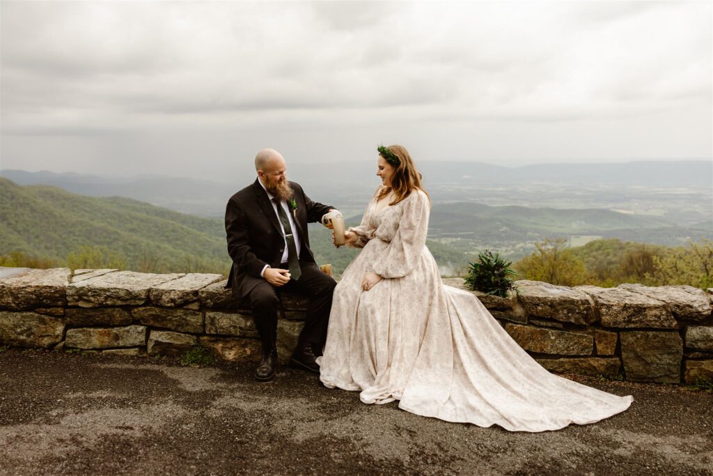 bride and groom enjoying mead at the mountaintop 