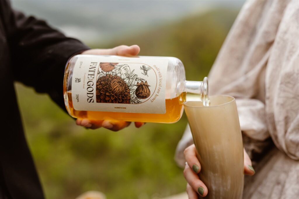 bride and groom enjoying mead at the mountaintop 