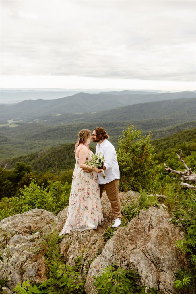 bride and groom kissing at a mountain overlook in shenandoah national park