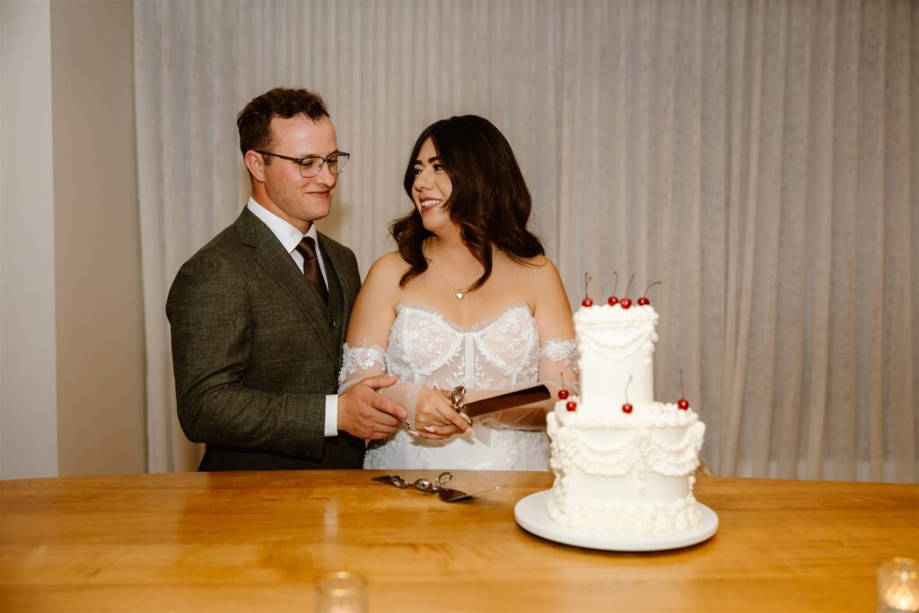 bride and groom cutting their vintage inspired 2 tiered wedding cake