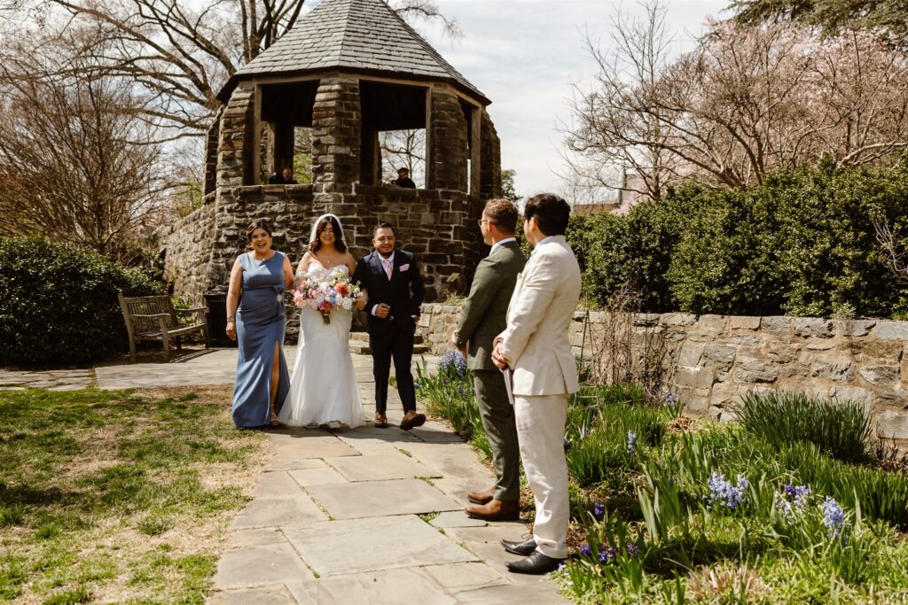 bride walking down the aisle with her parents