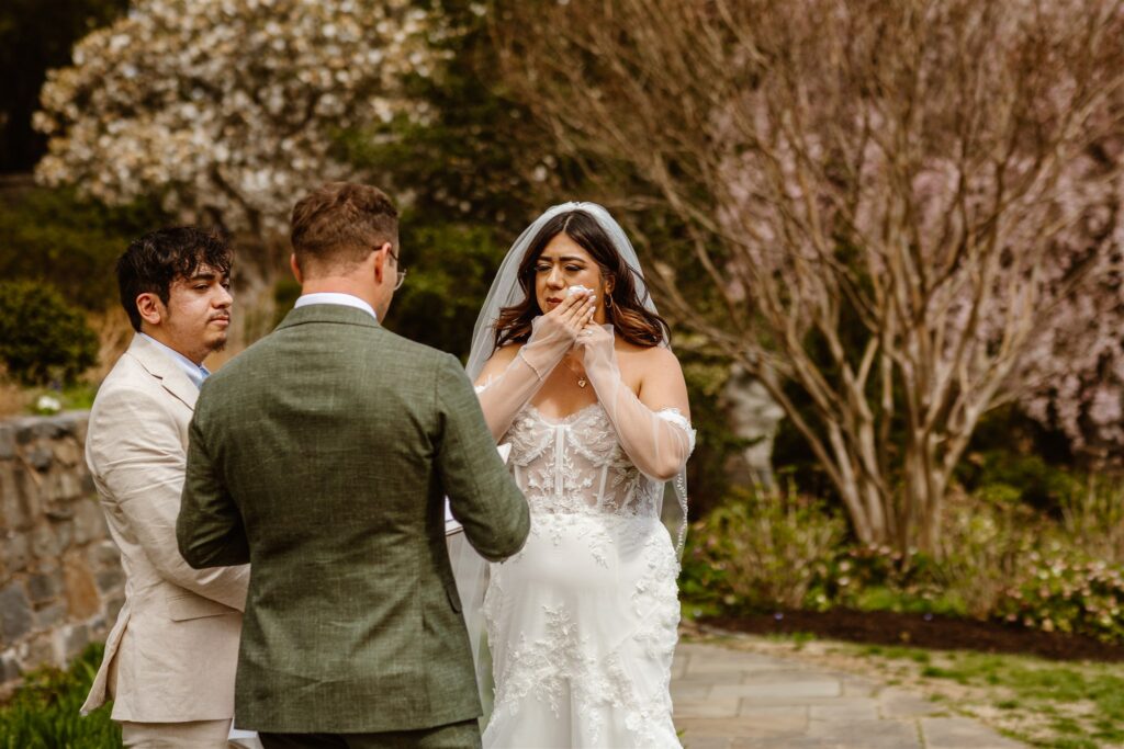 intimate micro wedding ceremony in front of the national cathedral surrounded by cherry blossoms