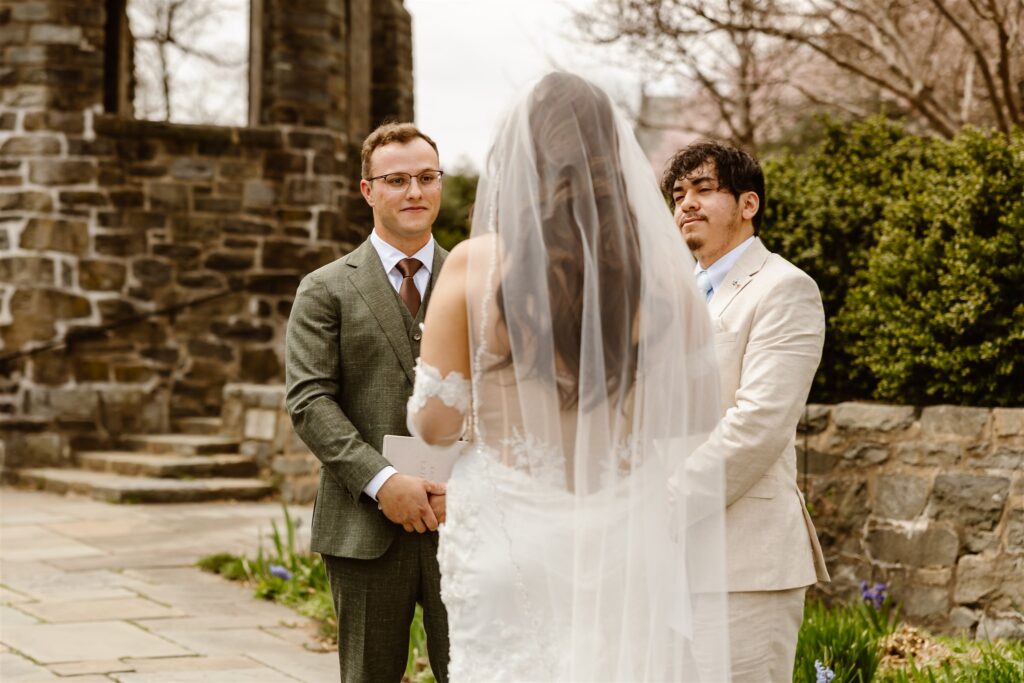 intimate micro wedding ceremony in front of the national cathedral surrounded by cherry blossoms