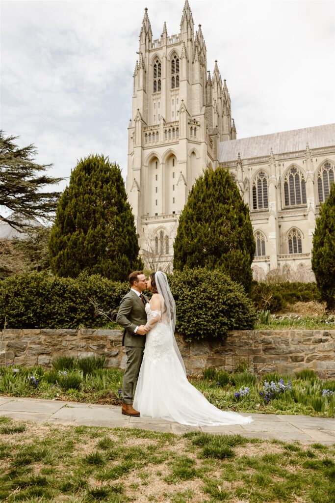 bride and groom exploring the national cathedral gardens during their dc cherry blossom wedding day