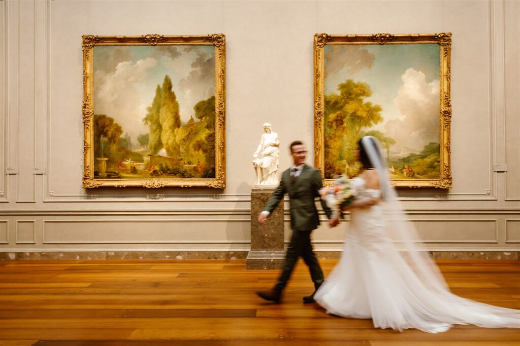 bride and groom walking in front of the gorgeous artwork at the national gallery of art