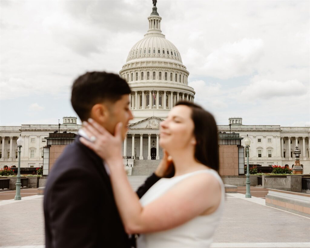 bride and groom kissing in front of the library of congress