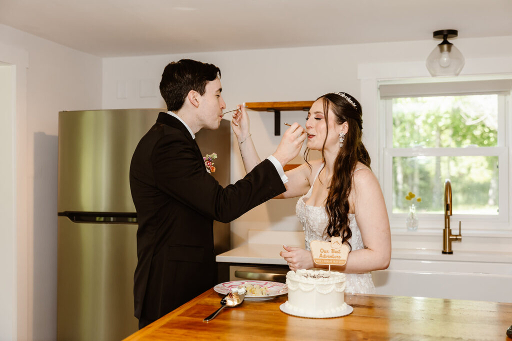 bride and groom feeding each other cake